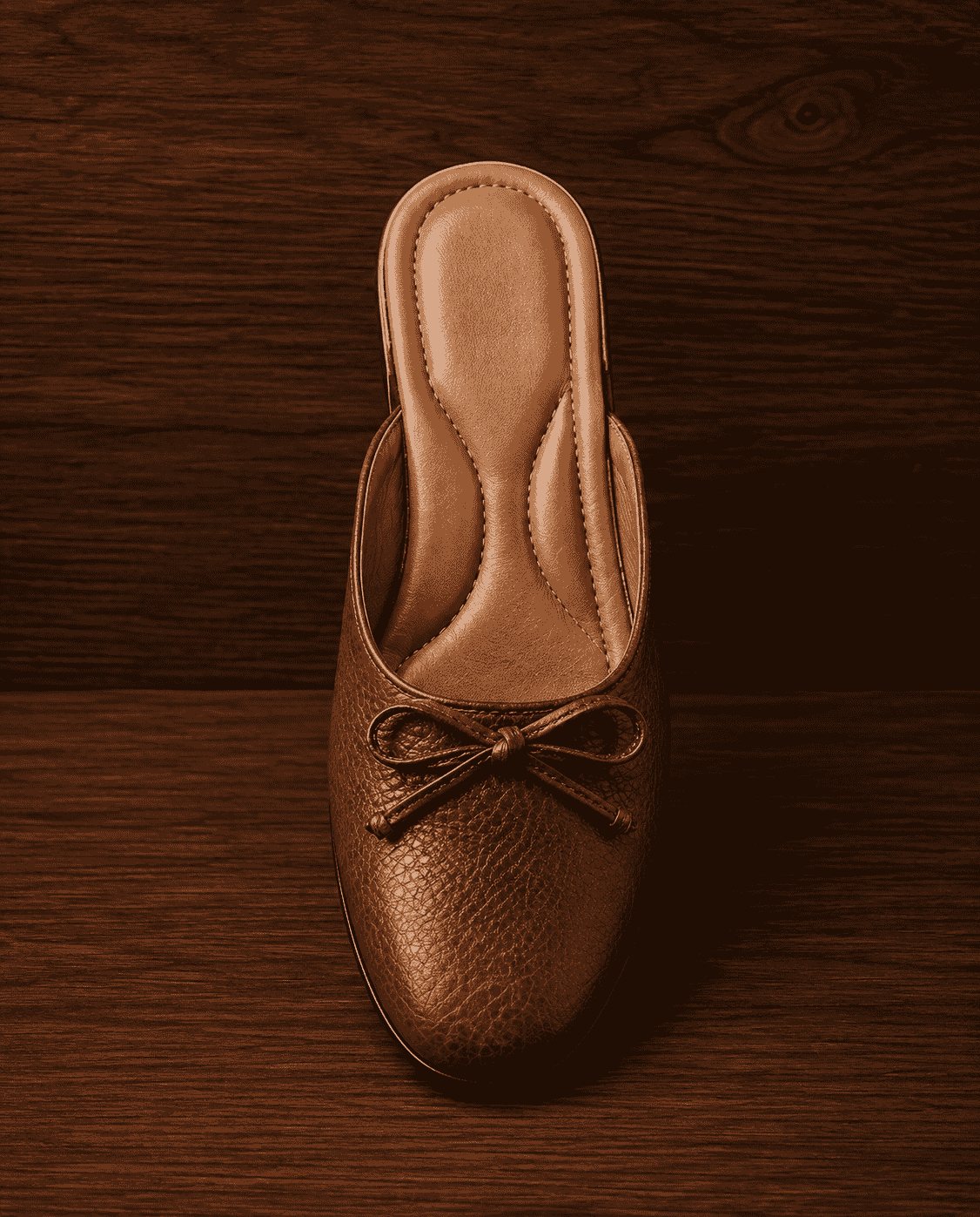 Tan pebbled leather mule with bow accent top view